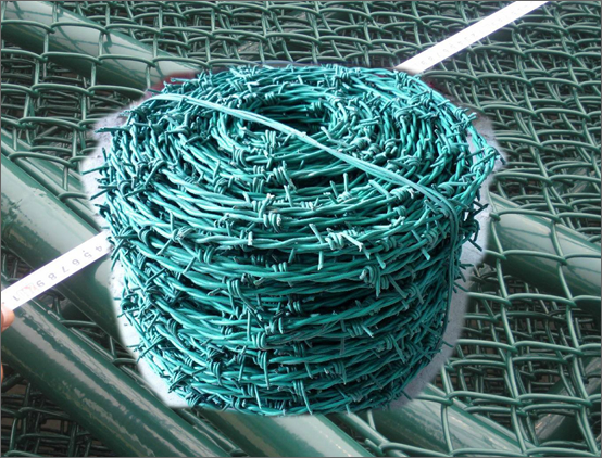 Twisted barbed wire used with chain link mesh